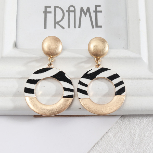 zebra print on matte gold circle earrings hung from stud on posts