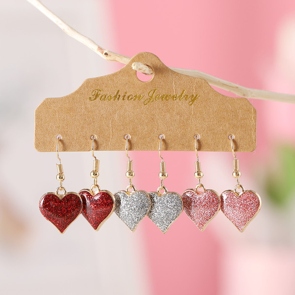 Glittery pink heart drop earrings on gold hooks