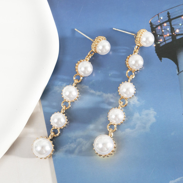 Gold drop earrings with faux pearls on posts