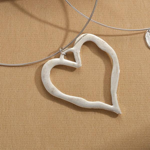Silver coloured heart pendant on choker