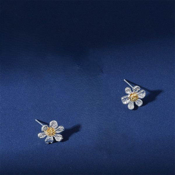Silver coloured daisy stud earrings on posts