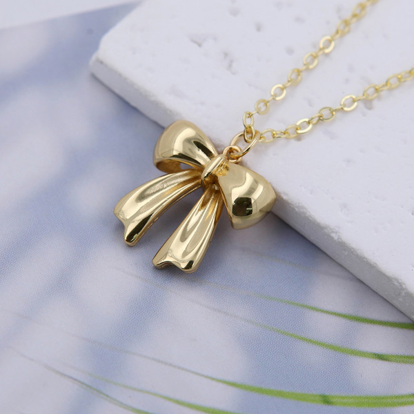Gold colour chain necklace with cute bow pendant