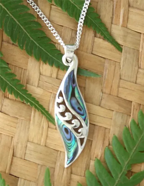 Angel's wing shaped sterling silver pendant with cut-out koru pattern and NZ paua shell inlay