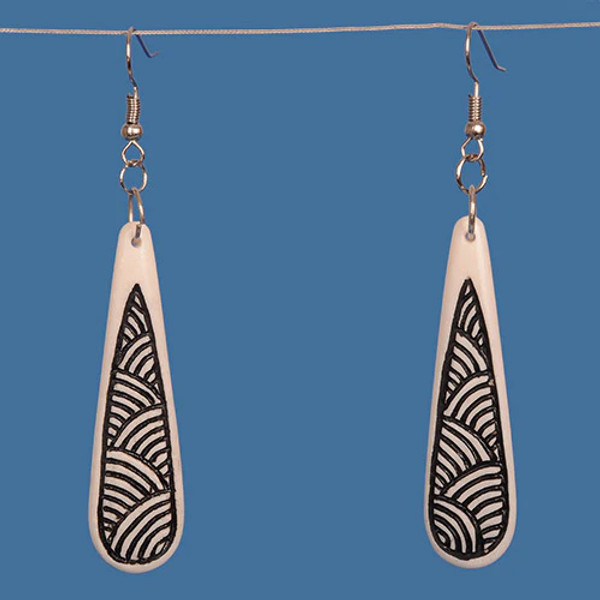 Bone drop earrings with engraved black design