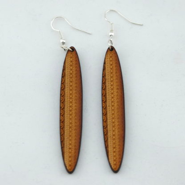 Long wooden oval earrings with tattoo design on hooks