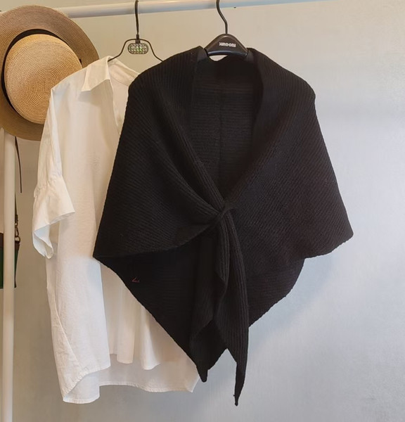Women's warm knit black cape with pull-through fastener