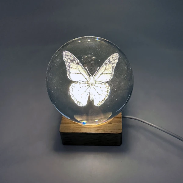 Butterfly etched crystal ball night light glowing