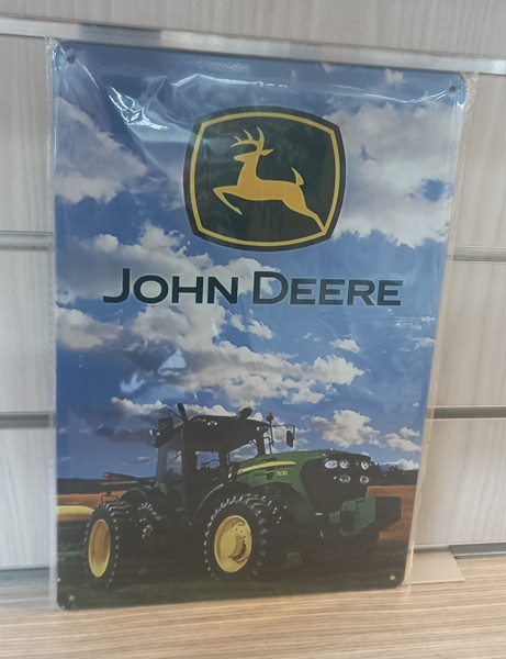 John Deere tractor in field tin sign