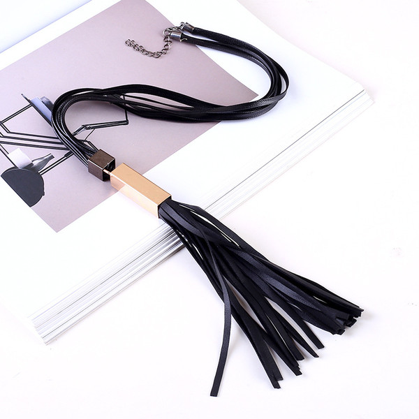 black multi strap necklace with gold tube and pu leather tassel