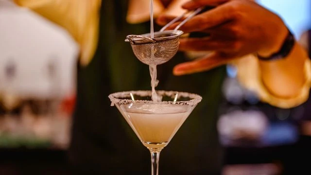 Cocktail party setup with drinks and event furniture