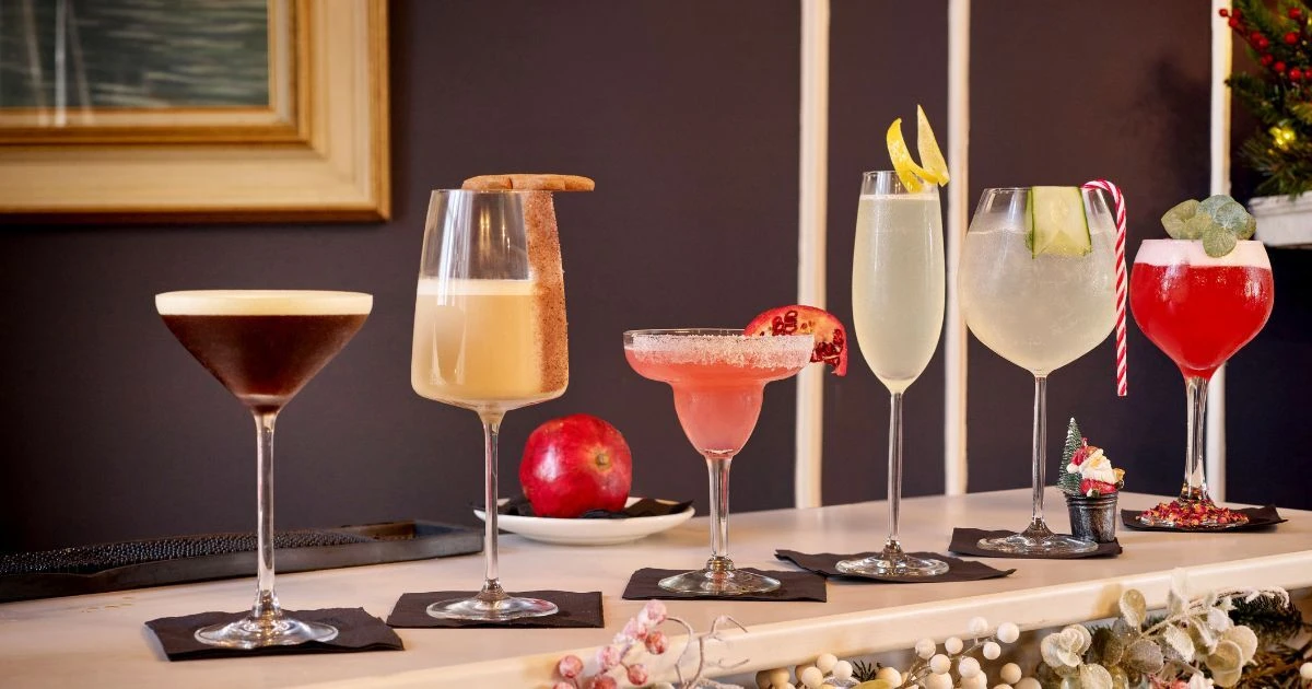 Guests enjoying an indoor drinks reception with CaterHire glassware and bar hire