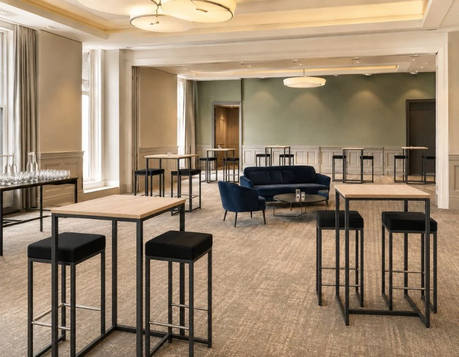 Pod tables and stools arranged for corporate networking