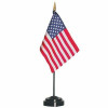 A small American flag on a stick. The black staff is topped with a gold-painted spear ornament. 