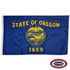 The blue Oregon flag has the text “State of Oregon / 1859” surrounding an eagle, ships, and a wagon. FMAA Certified Made in America seal.