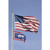 The Wyoming flag on a flagpole, flying below the American flag.