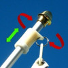 A diagram shows how a non-furling device attaches to a silver flagpole and is clipped to a flag’s grommet.