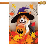 A Corgi Fall House Flag depicting a corgi wearing a cape and witch's hat, holding a pumpkin basket in its mouth and surrounded by fall leaves.