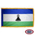 The indoor Lesotho flag is a horizontal blue, white, and green tricolor. In the center of the wider white stripe is a black mokorotlo. FMAA Certified Made in America seal.