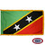 The indoor St. Kitts-Nevis flag has 3 sides of gold fringe around 2 green and red triangles separated by a black stripe with 2 white stars. FMAA Certified Made in America seal.