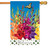 A house flag depicting a colorful garden of Gladiolus flowers with a blue sky and a yellow butterfly above. Below is a white fence with a sign reading "Welcome".