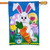 A Happy Easter Bunny and Carrot Garden Flag depicting a large white rabbit holding an orange carrot in front of Easter eggs. A Happy Easter Bunny and Carrot Garden Flag depicting a large white rabbit holding an orange carrot in front of Easter eggs.