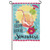 A garden flag depicting a large orange drink with a straw and lime wedge in front of a sun and light blue background. Below is the text "It's Happy Hour Somewhere" in black script.