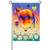 A garden flag depicting a group of colorful hot air balloons floating above a field of white flowers.