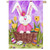 The long eared bunny brightens the front of any home with a perky white bunny dressed in pink sitting in a brown wicker laundry basket.  The basket is in a yard surrounded by colorful Easter eggs.