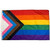 The Progressive Pride Flag featuring horizontal stripes of red, orange, yellow, green, blue and purple. Over the left side there are triangular stripes of white, pink, blue, brown, and black. 