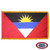 The indoor Antigua & Barbuda flag has 3 sides of gold fringe around a red field with an upside-down multicolor triangle depicting a rising sun. FMAA Certified Made in America seal.