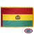 The indoor Bolivia flag has 3 sides of gold fringe around a red, yellow, and green tricolor. In the center of the yellow stripe is the state seal. FMAA Certified Made in America seal.