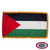 The indoor Palestine flag has 3 sides of gold fringe around a horizontal black, white, and green tricolor. On the left is a red triangle. FMAA Certified Made in America seal.