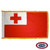 The indoor Tonga flag has 3 sides of gold fringe around a red field with a white canton that contains a red cross. FMAA Certified Made in America seal. The indoor Tonga flag has 3 sides of gold fringe around a red field with a white canton that contains a red cross. FMAA Certified Made in America seal.