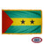 The indoor Sao & Tome flag has 3 sides of fringe around a green & yellow triband with two stars in the center & a red triangle on the left. FMAA Certified Made in America seal.