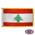 The indoor Lebanon flag has 3 sides of gold fringe around 3 red and white stripes. In the center of the wider white stripe is a cedar tree. FMAA Certified Made in America seal.
