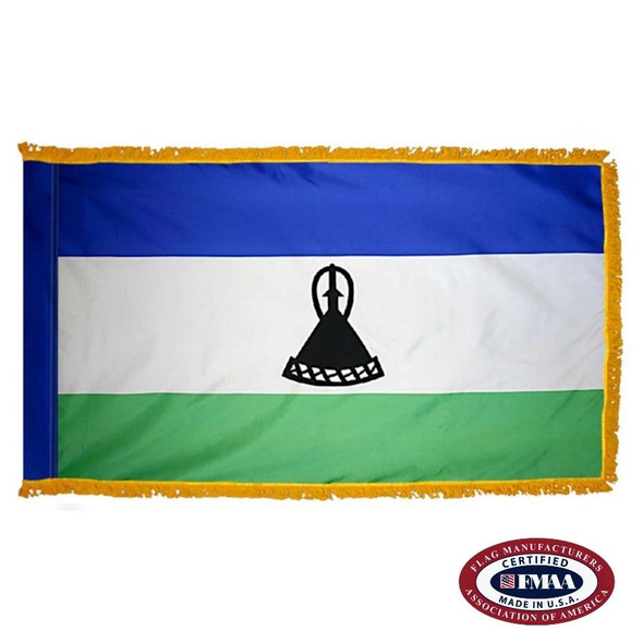 The indoor Lesotho flag is a horizontal blue, white, and green tricolor. In the center of the wider white stripe is a black mokorotlo. FMAA Certified Made in America seal.