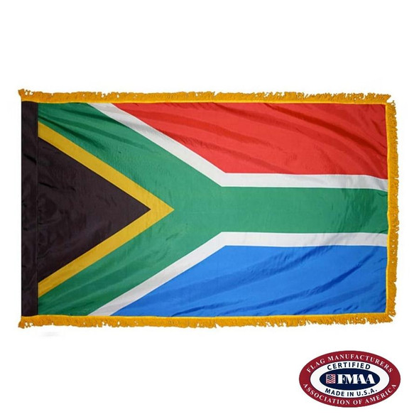 The indoor South Africa flag has 3 sides of gold fringe around black, red, and blue fields separated by a green “Y” shape facing left. FMAA Certified Made in America seal.
