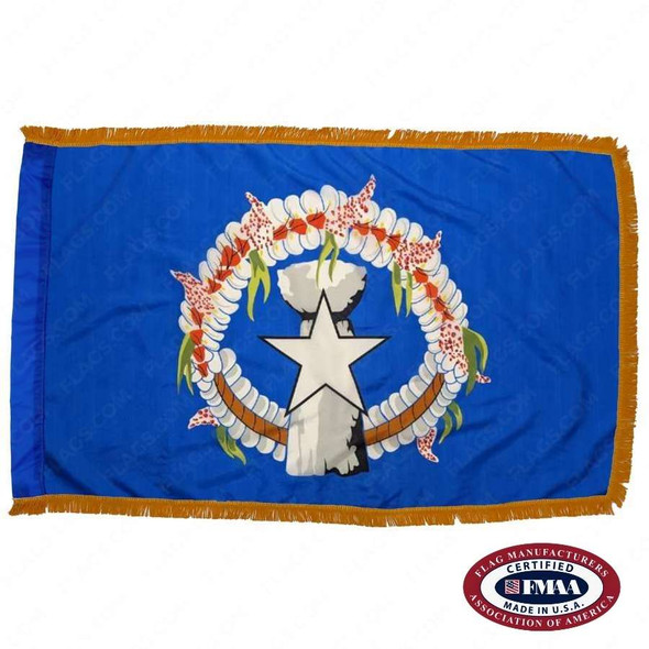 The indoor Northern Mariana Islands flag has 3 sides of fringe around a blue field with a white star, gray latte, and wreath in the center. FMAA Certified Made in America seal.