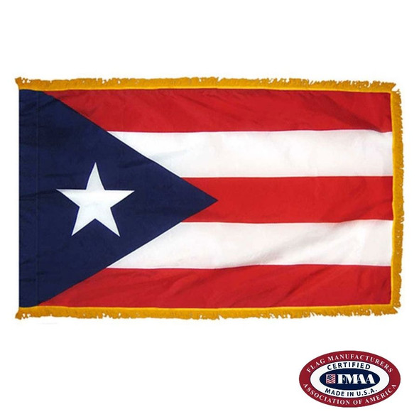 The indoor Puerto Rico flag has 3 sides of fringe around 5 horizontal red & white stripes. On the left is a blue triangle with a white star. FMAA Certified Made in America seal.