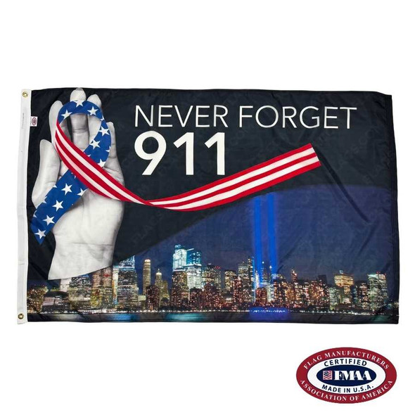 The 9/11 Tribute in Light Flag depicts a hand holding a ribbon with an American flag design, above the New York skyline with two lights representing the Twin Towers. Above is the white text “Never Forget 911”. FMAA Made in America seal.