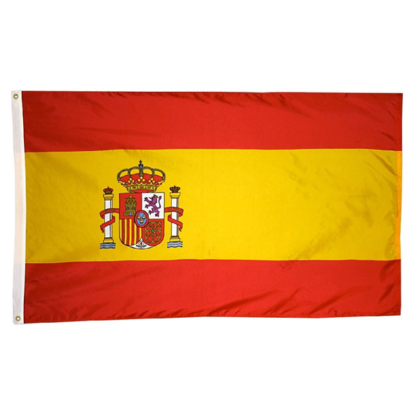 The Spain flag, a tricolor rectangular flag consists of two smaller red stripes at the top and bottom with a yellow stripe that is twice the width of the red. Closer to the white canvas header with brass grommets, on the left-hand side, and in the middle of the yellow stripe, you will find the coat of arms of Spain. The coat of arms has a gold and red crown above the blazon. The blazon is separated into four parts. Each part represents the medieval kingdoms that came together to form the Spanish monarchy. On either side of the blazon, are the Pillars of Hercules with crowns on top of them. The motto “Plus Ultra” can be found on red banners that wrap around the pillars. On the flag’s left side (the hoisting side) are a canvas header and brass grommets for easy attachment to flagpoles.