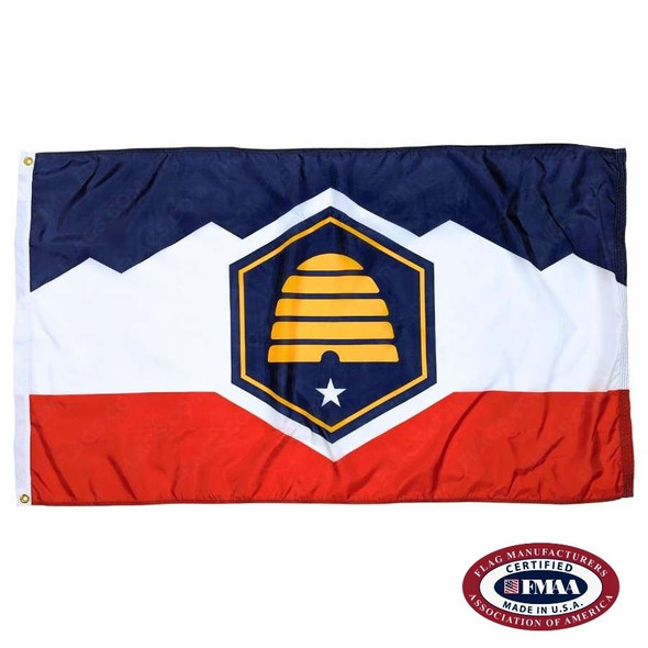 The Utah flag has a blue hexagon in the center with a yellow beehive & white star. Behind it are white mountains with a blue sky & red ground. FMAA Made in America seal.