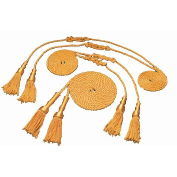 Three sets of gold cords and tassels are coiled up and placed next to one another.