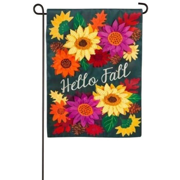 This Hello Fall Garden flag displays an embroidered 'Hello Fall' white text at the center of the flag. There are appliquéd sunflowers and leaves in various colors surrounding the text. Flower colors are orange, yellow, red, and magenta. Leaf colors are green, orange, and red. The background of the flag is black. The flag is displayed on a black garden pole sold separately.