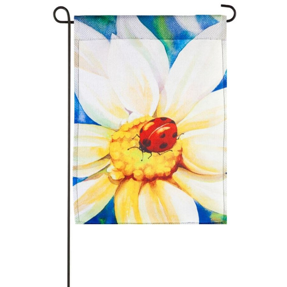A garden flag depicting a large white daisy with a ladybug in the center.