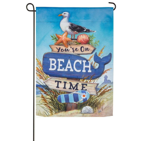A garden flag depicting a sign on a beach reading "You're on Beach Time" with a seagull perched on the top.