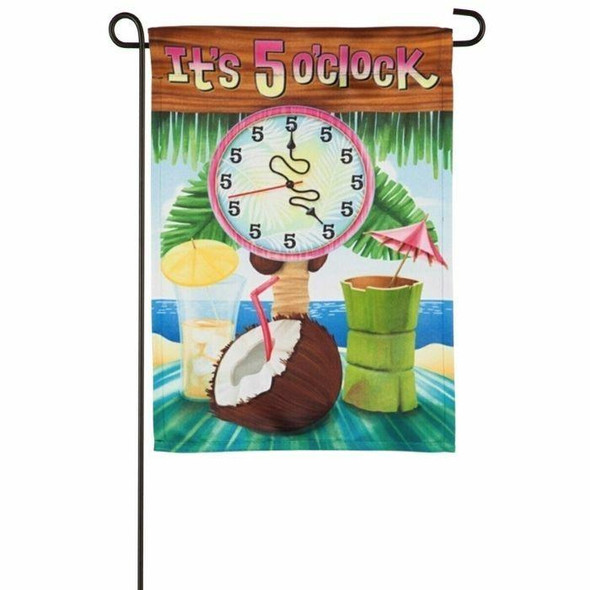 This garden flag features the beach in the background with a palm tree. There is a blue towel in the middle of the flag with a coconut drink, and two other cocktails with umbrellas in them. There is a clock with all 5's on the face and above the clock is the text "It's 5 o'clock."