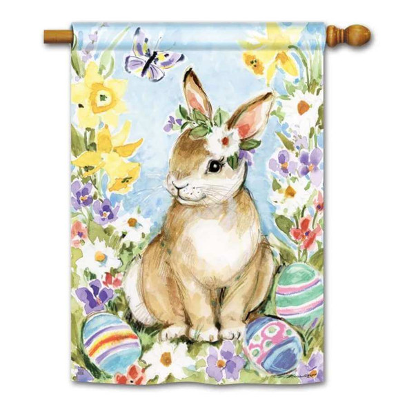 A house flag picturing a rabbit wearing a flower surrounded by Easter eggs and flowers.