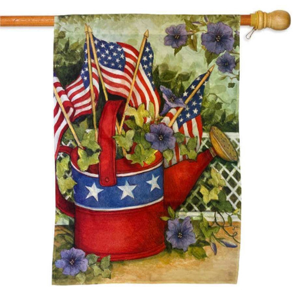 A flag with an American-themed watering can with flowers, leaves, and US flags coming out the top. The background is a garden with a fence.