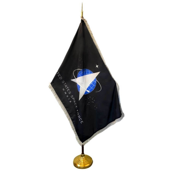The Space Force flag with silver fringe is mounted on a wooden flagpole with a golden base.